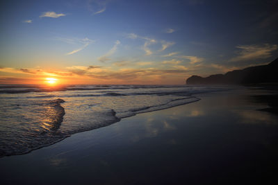 Scenic view of beach against sky during sunset