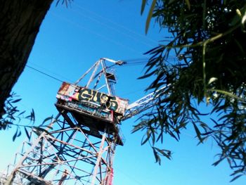 Low angle view of construction site against clear blue sky