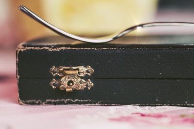 Close-up of old machine part on table