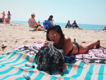 Young woman sitting on beach