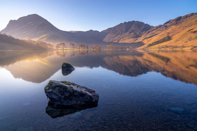 Scenic view of lake and mountains against sky