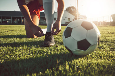 Low section of man playing soccer