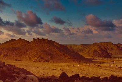 Scenic view of mountain against cloudy sky