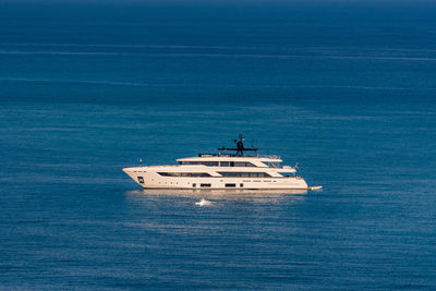 Ship sailing in sea against blue sky