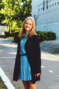 Portrait of young woman standing outdoors