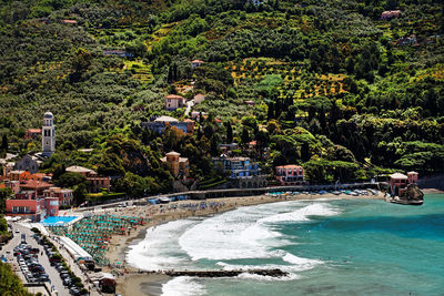 Scenic view of beach by village on mountain