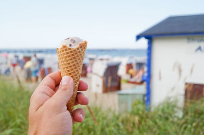 Close-up of hand holding ice cream cone