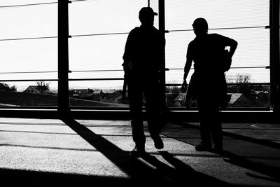 Silhouette people standing against sky