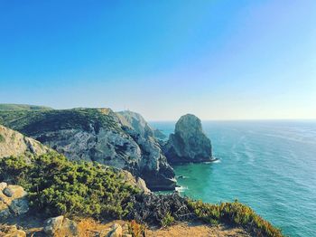 Scenic view of sea against clear blue sky