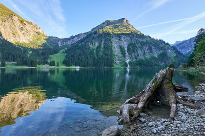 Scenic view of lake and mountains against sky