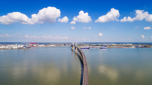 High angle view of bridge over river against sky in city