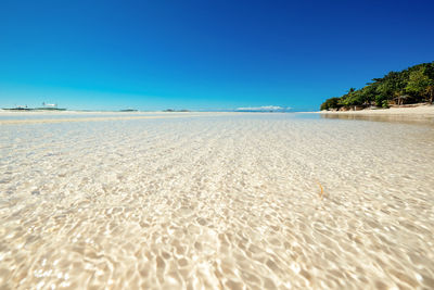 Scenic view of beach against clear sky