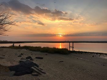 Scenic view of beach against sky during sunset