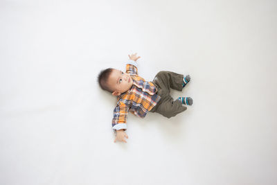 Cute boy playing on white background