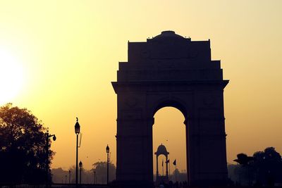 Low angle view of built structure at sunset