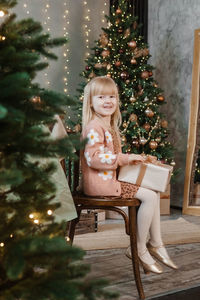 Portrait of young woman sitting on chair