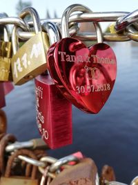 Close-up of love locks hanging on chain