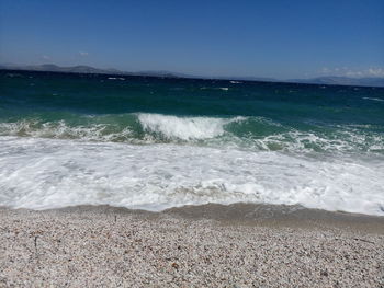 Scenic view of beach against blue sky