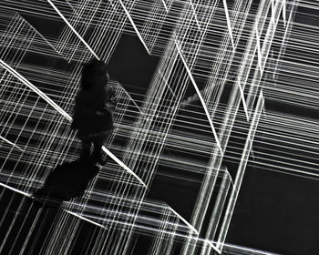 Full frame shot of illuminated spider web against black background