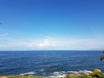 Scenic view of sea against blue sky