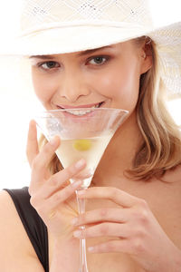 Portrait of a beautiful young woman drinking glass