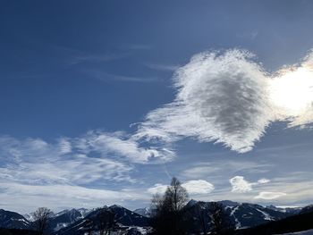 Low angle view of snowcapped mountains against sky