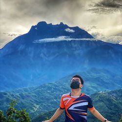 Man on snowcapped mountain against sky