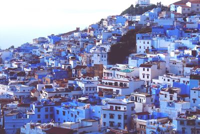 High angle view of cityscape against blue sky