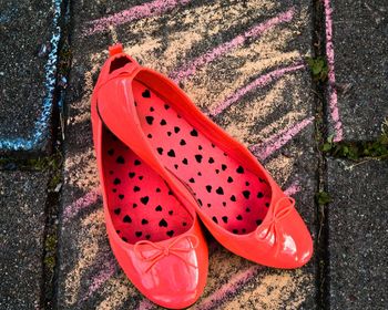 High angle view of red shoes on footpath