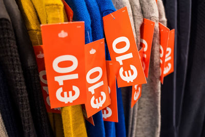 Close-up of information sign on clothes for sale in market