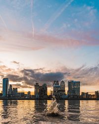 City at waterfront during sunset