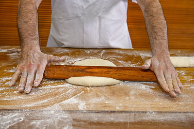 Midsection of man preparing food