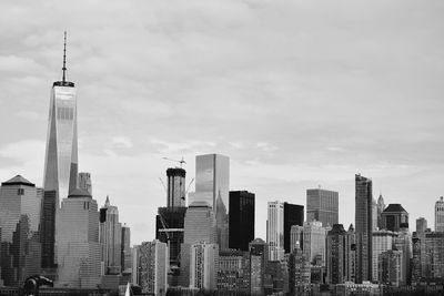 Skyscrapers against cloudy sky