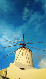 Low angle view of traditional windmill against sky