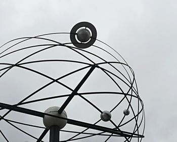 Low angle view of electric lamp against sky