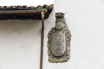 Low angle view of statue against wall