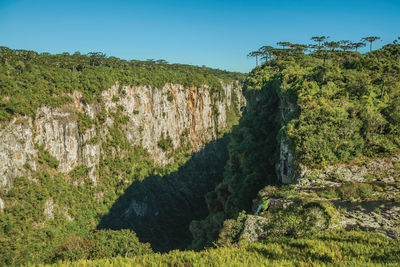 Itaimbezinho canyon with steep rocky cliffs going through a flat plateau, in cambará do sul, brazil.