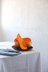 Close-up of ice cream on table against wall