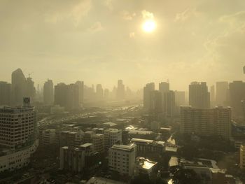 Aerial view of buildings in city against sky