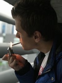 Close-up of man lighting marijuana joint