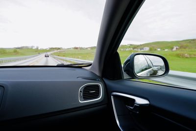 View of side-view mirror of car