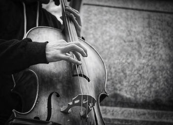 Midsection of man playing cello