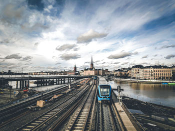 High angle view of railroad tracks in city against sky