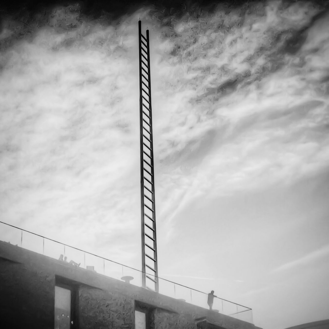 low angle view, sky, cloud - sky, cloudy, built structure, connection, architecture, cloud, engineering, overcast, bridge - man made structure, day, no people, outdoors, railing, metal, weather, tall - high, industry, communication