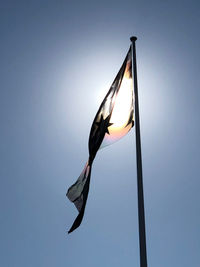 Low angle view of flag against clear sky