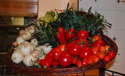 Close-up of tomatoes with vegetables in kitchen