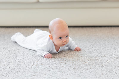 Close-up of cute baby boy on floor
