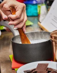 Cropped hand of person preparing food