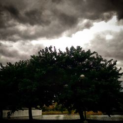 Scenic view of river against cloudy sky