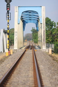 Railroad tracks amidst trees against sky